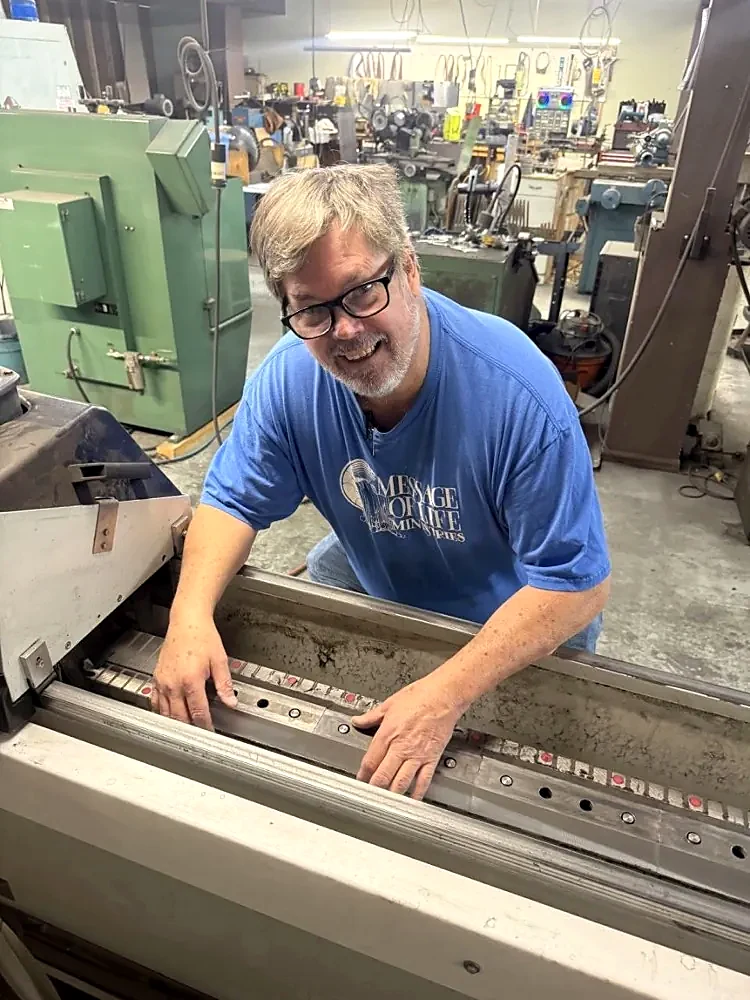 Paul working at a sharpening machine inside Rocky Mountain Sharp Shop