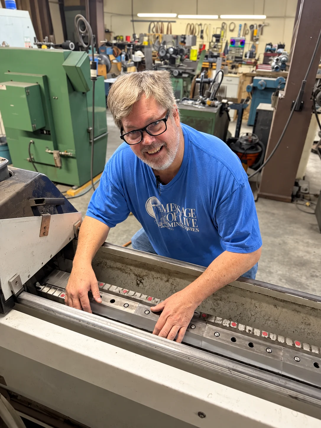 Paul, the owner, working a blade on the sharpening machine