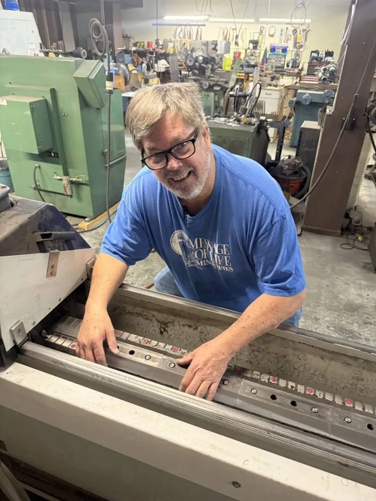 Paul, the owner, working a blade on the sharpening machine